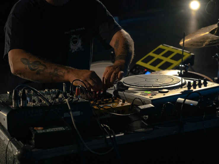 a person working on an electronic device with some light on