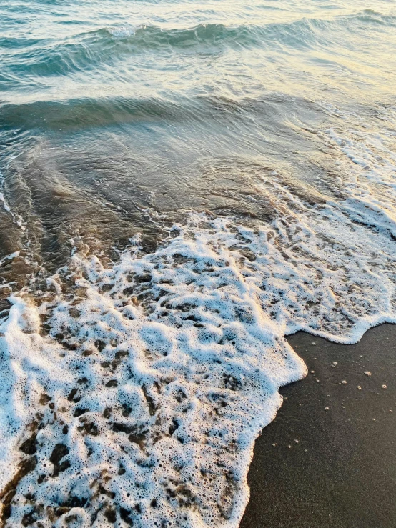 the water is running along the black sand beach