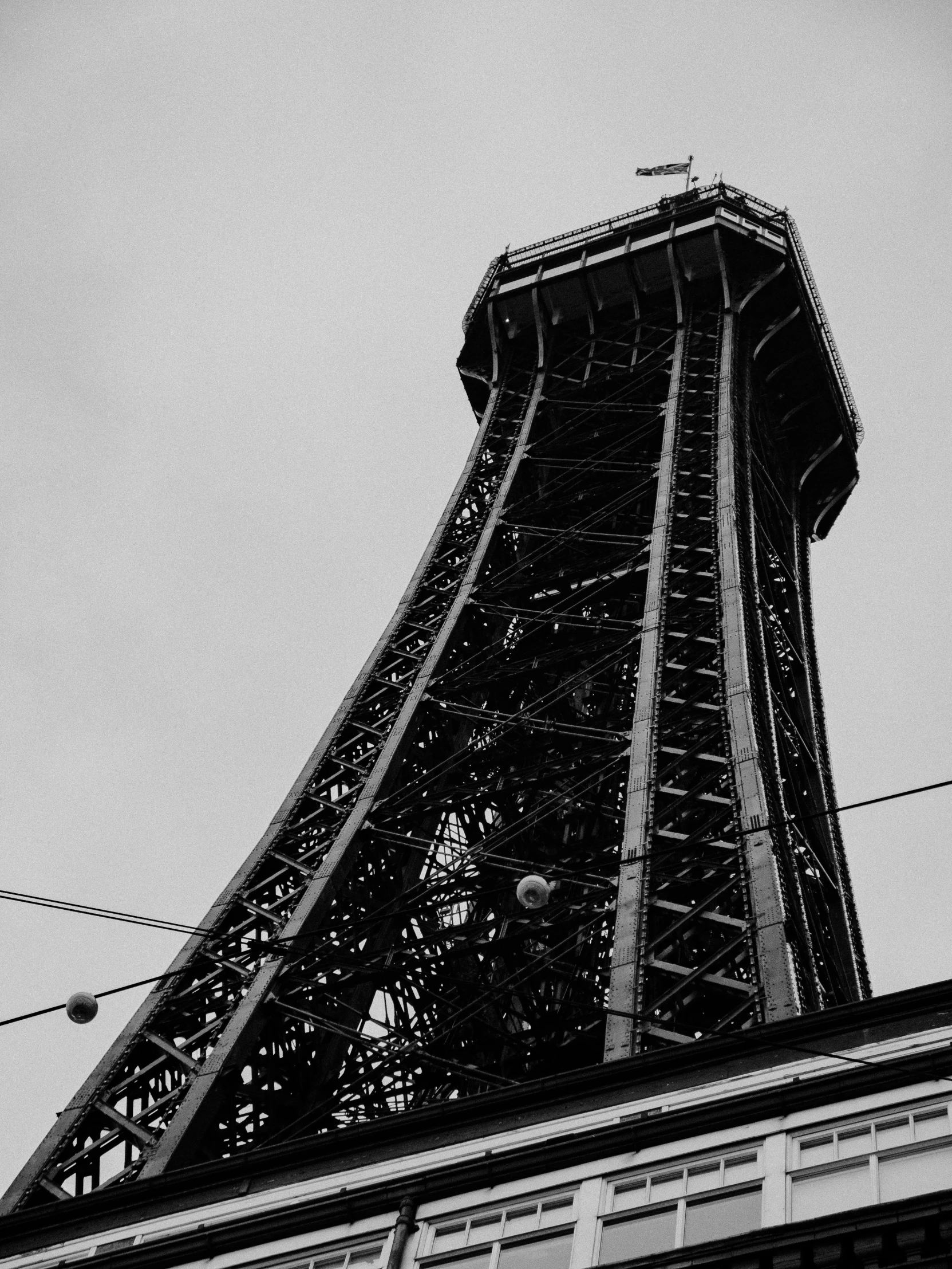 a very tall tower near power lines and wires