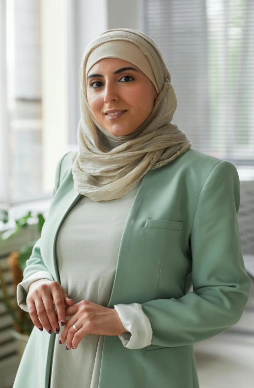 an image of woman standing in room wearing hijab