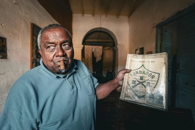 a man smokes a cigar while holding a bag of cigar