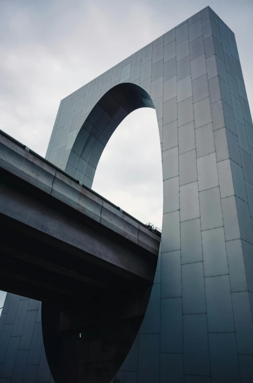 a concrete arch on the road beside a highway