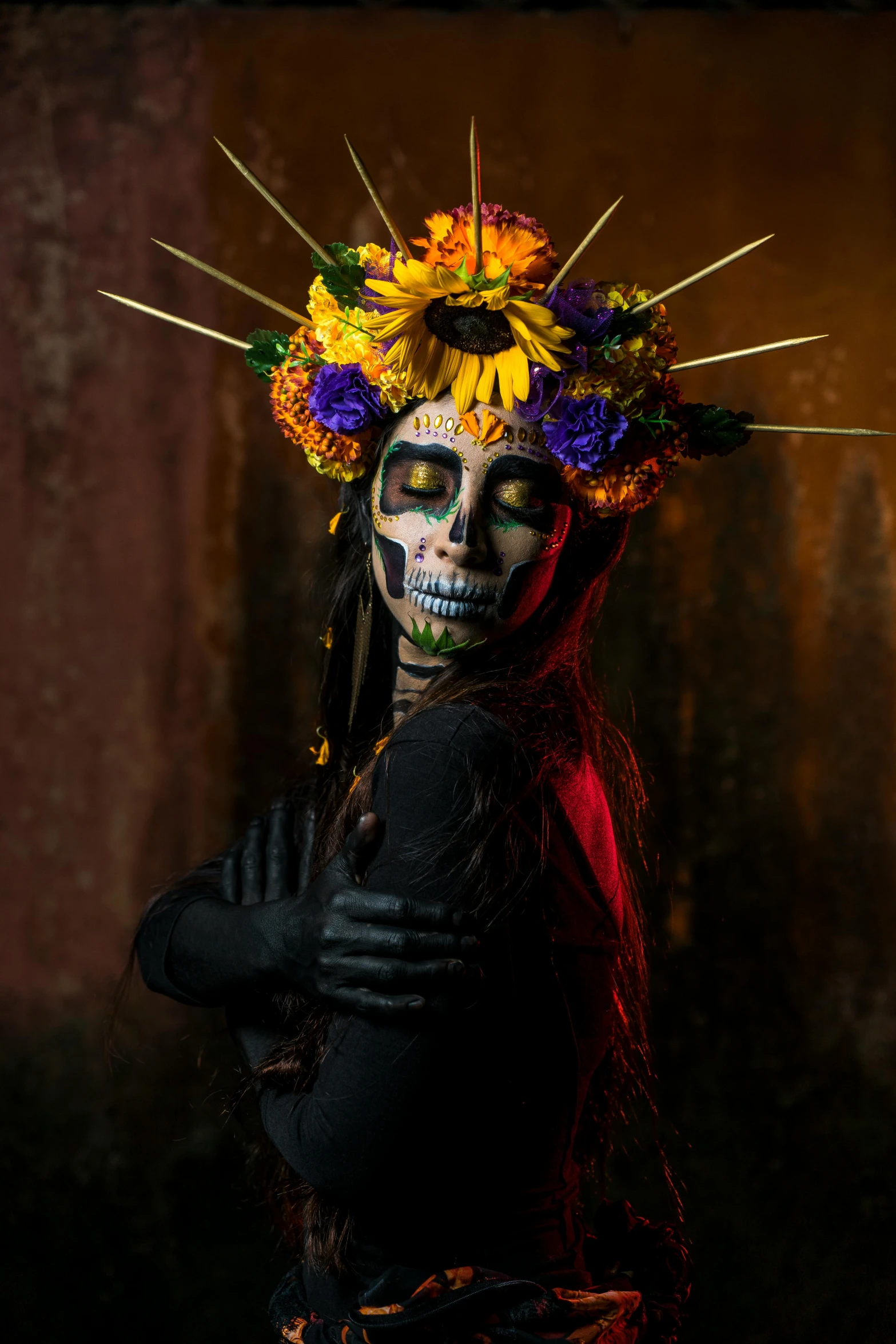 a woman in skeleton makeup and flowers wearing a flower crown