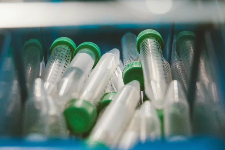 a lot of different types of plastic tubes in a metal bin