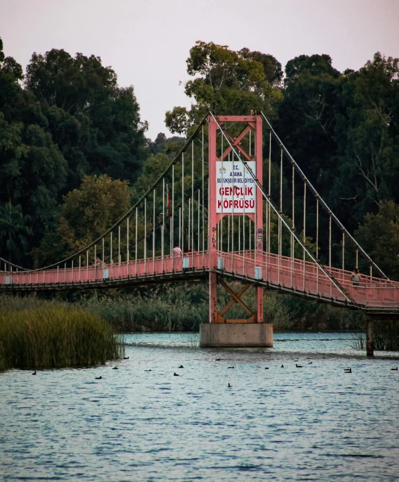 the view from the shore of a bridge across a body of water