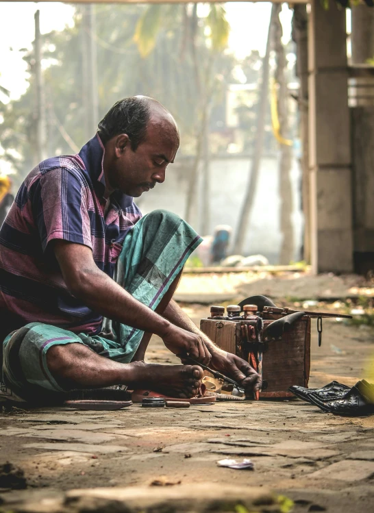 a man kneeling on the ground using soing on it