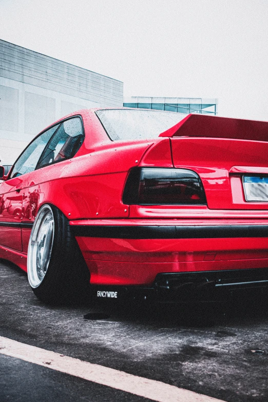 a red car is parked on the street