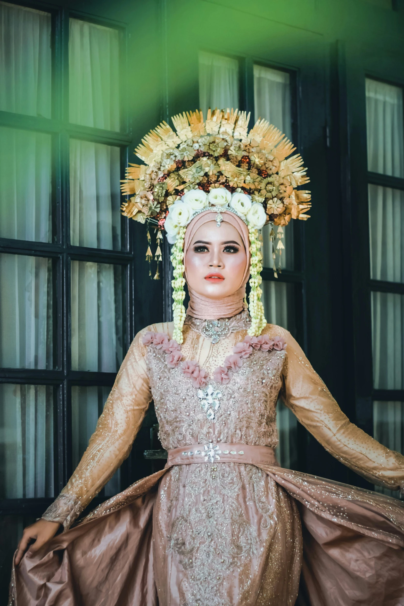 a lady in an elaborate golden dress holding two arms out