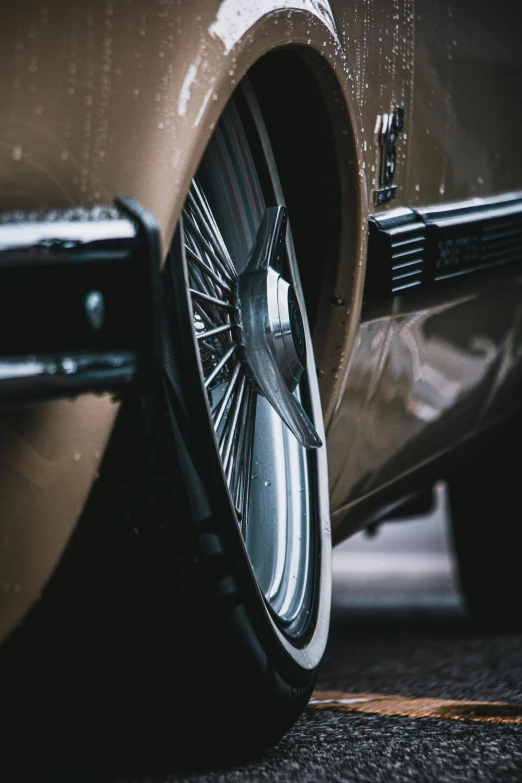 wheels from a classic car with spokes are on the road