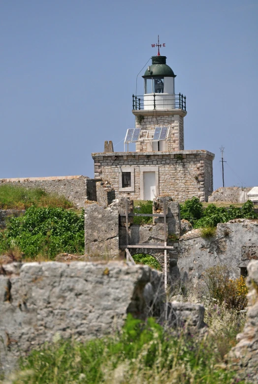 an old, stone - built building has a turret with a small roof