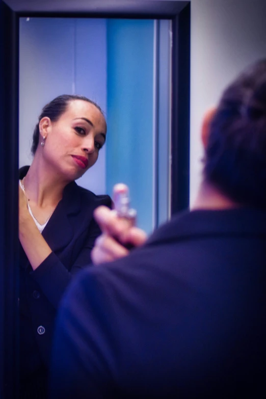 woman looking at herself in the mirror