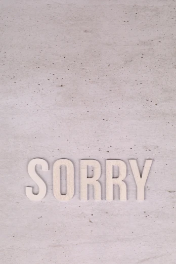 the word sorry written in large, lettered white type