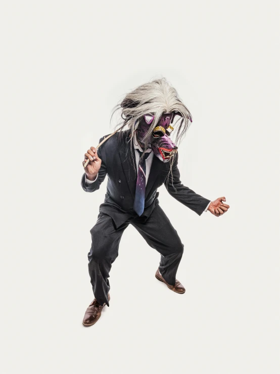 man in a suit flying in the air with dreads on his hair