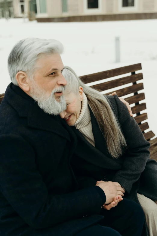 a man and woman are sitting on a bench