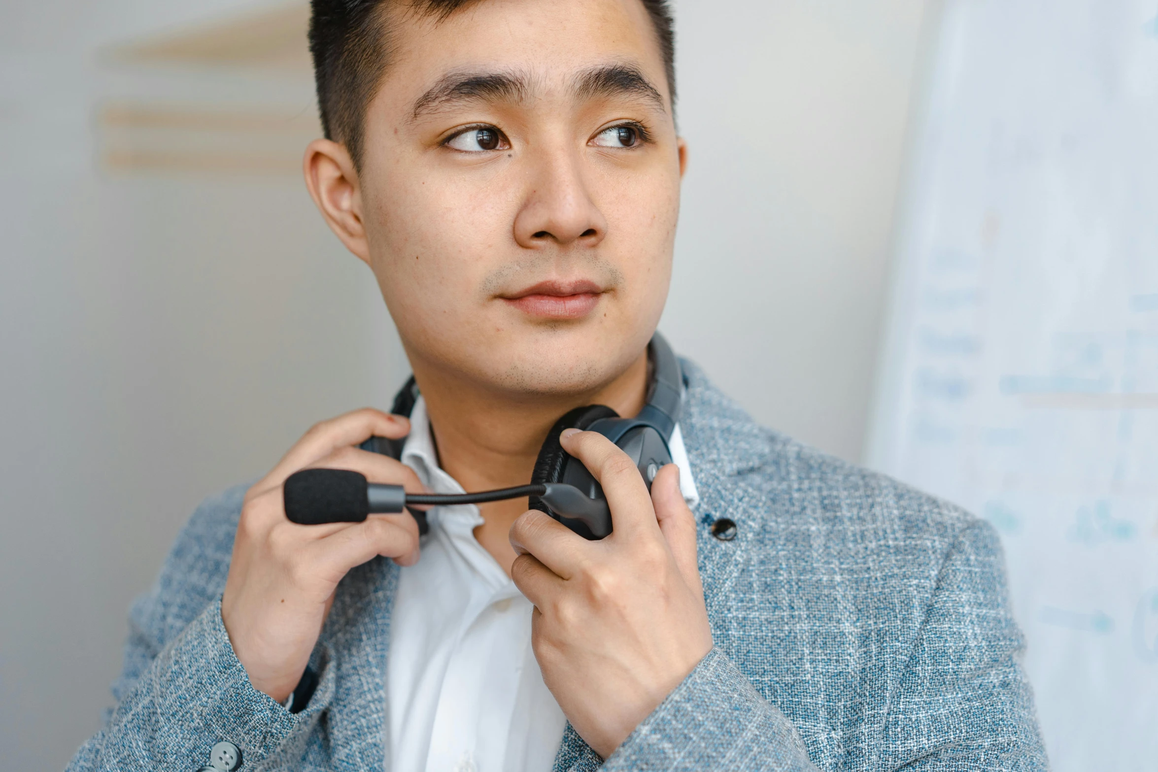 a man adjusting his neck with ear phones