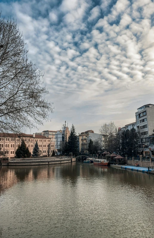 a river runs through a town on a cloudy day