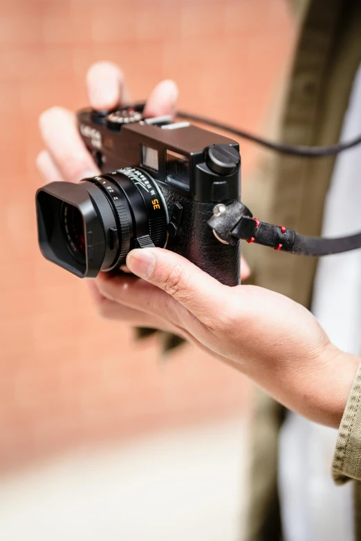 person holding a video camera up to the side of his body