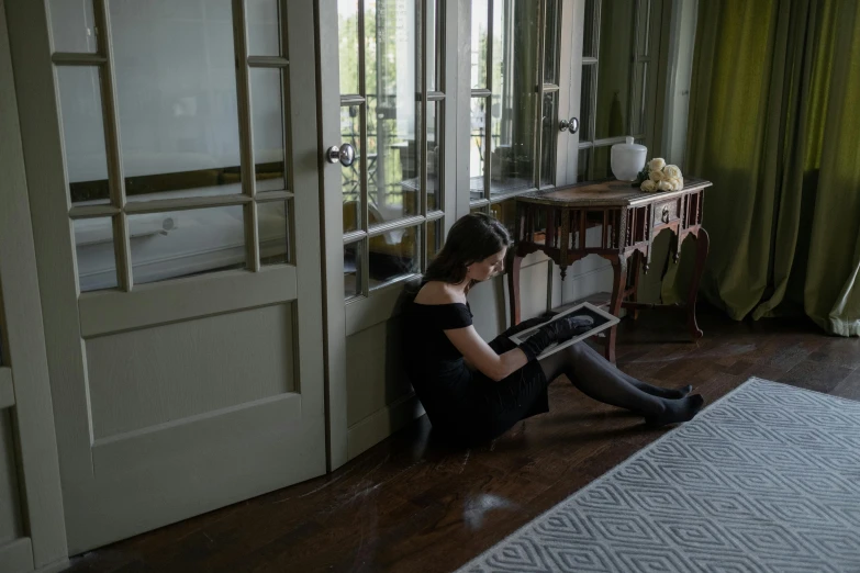 a woman in black knee boots sitting on the floor