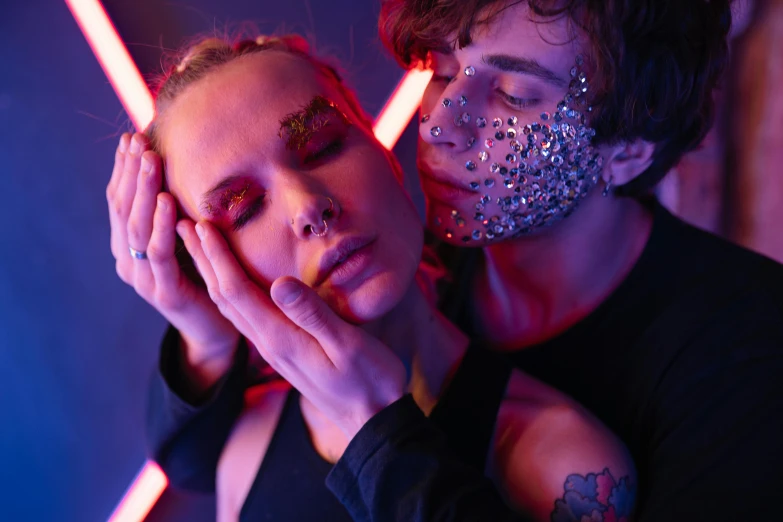 two people in artistic makeup and dark colors