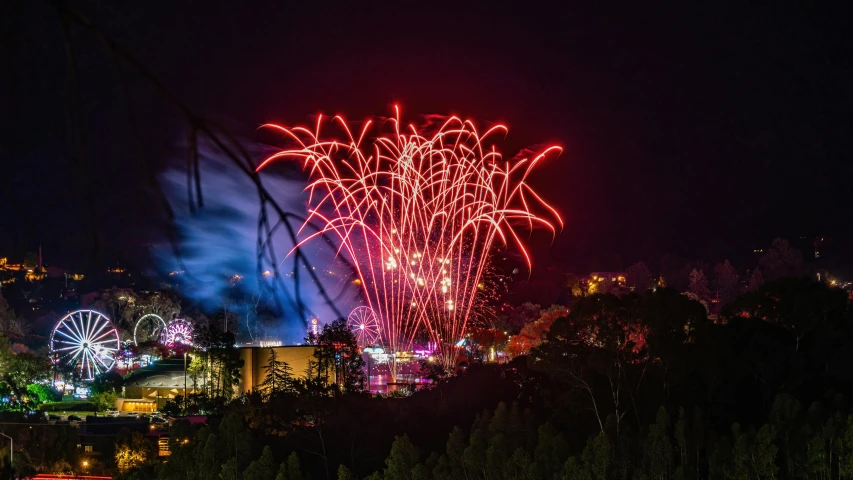 a nighttime fireworks display is seen from the outside