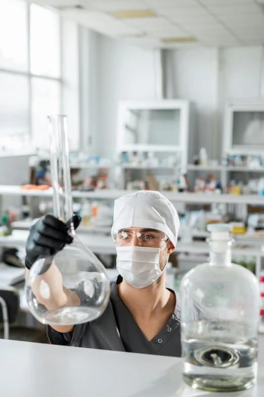 an employee at a laboratory with a tube and a tube in hand