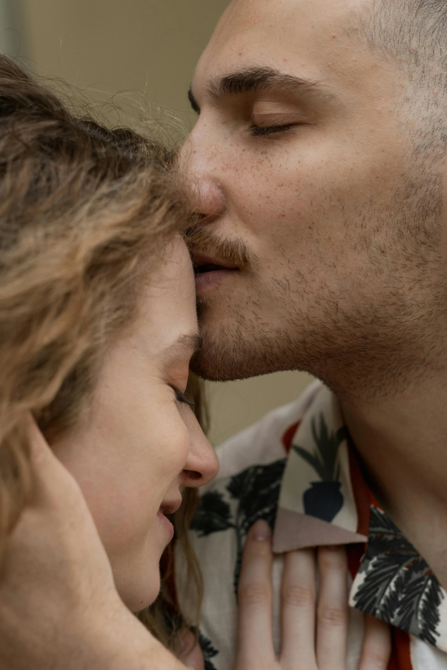 a young woman and a man kissing each other