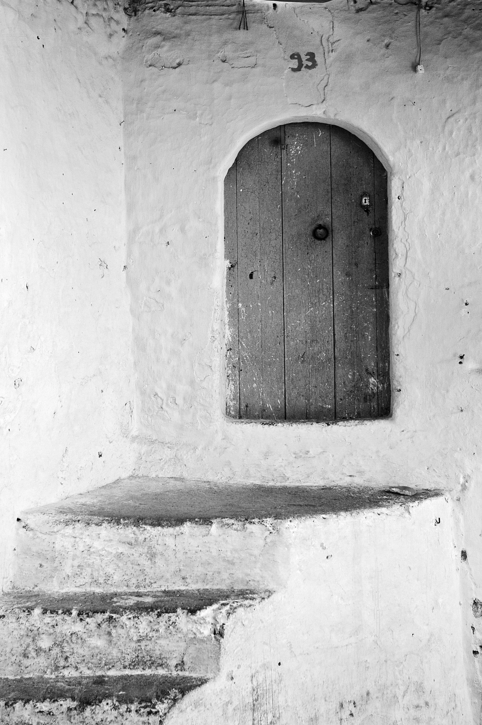 a wooden door sitting inside of a stone wall