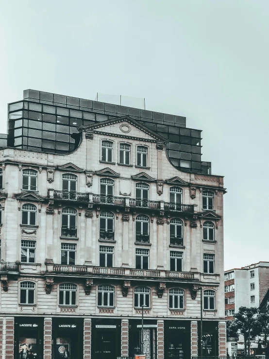 old architecture in a city setting with an old building and cars parked by