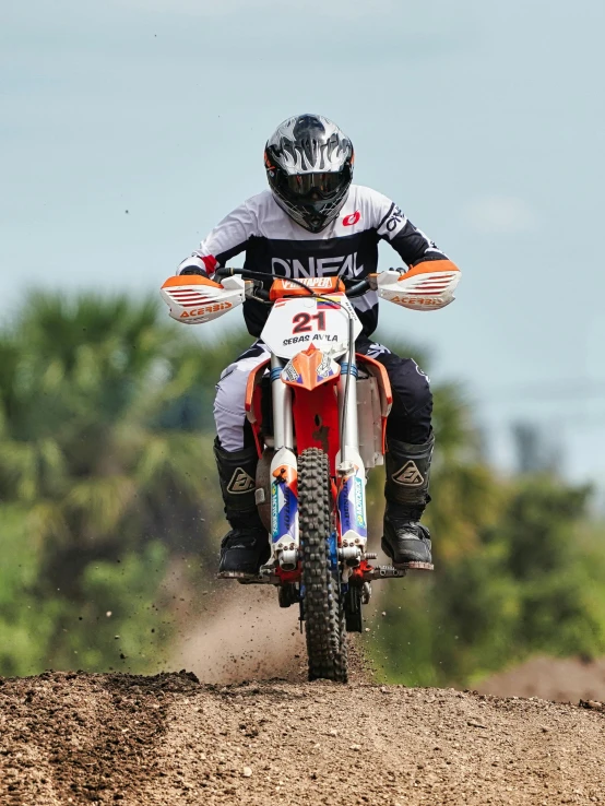 a motorcycle racer riding on a dirt track