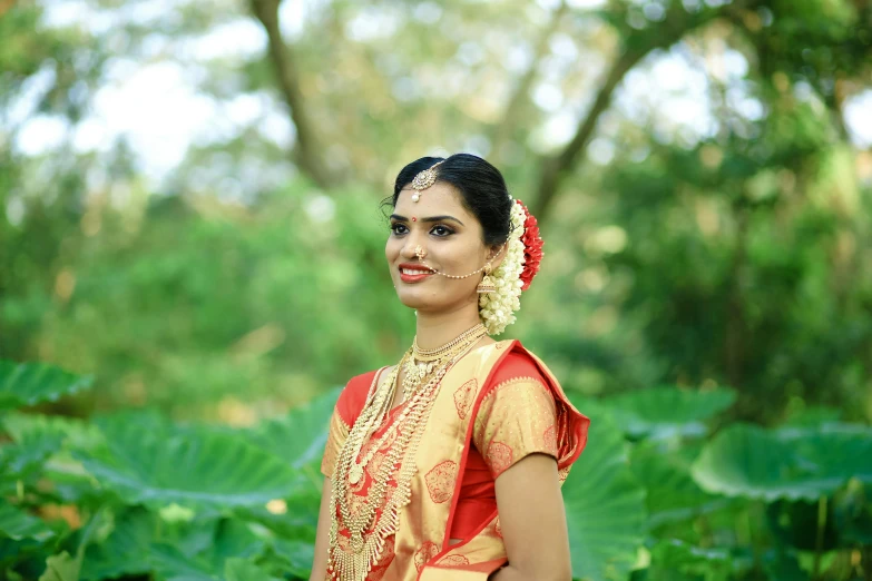 an indian woman in red and gold clothing