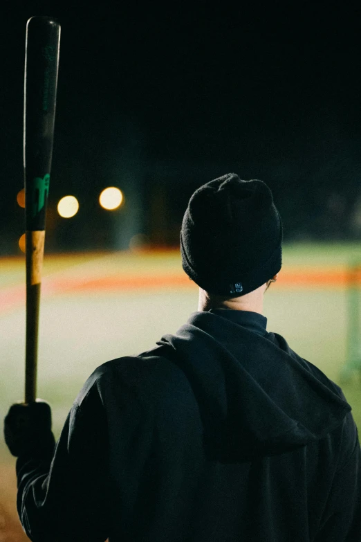 a man stands on a court holding a bat