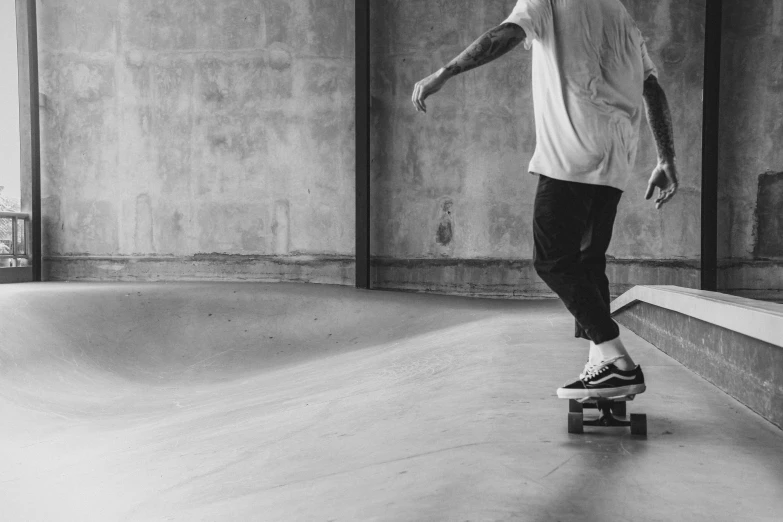 a black and white image of a person on a skate board