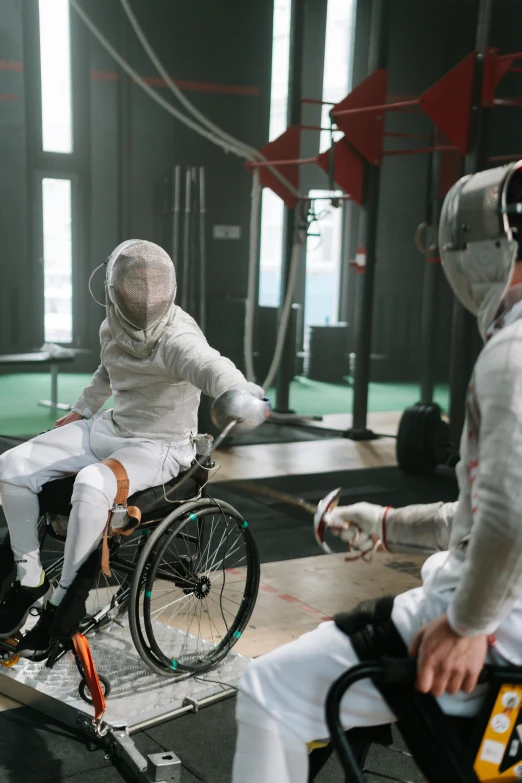 the men in white suit are performing tricks on their wheels