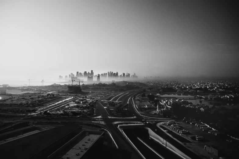 black and white pograph of a city skyline taken over a road