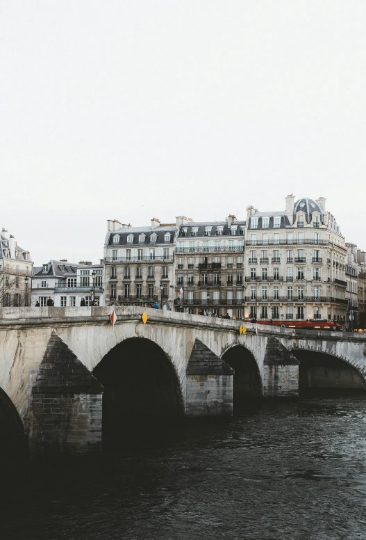 a bridge over a body of water surrounded by buildings