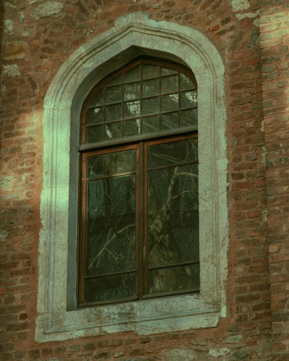 a very tall brick building with some glass