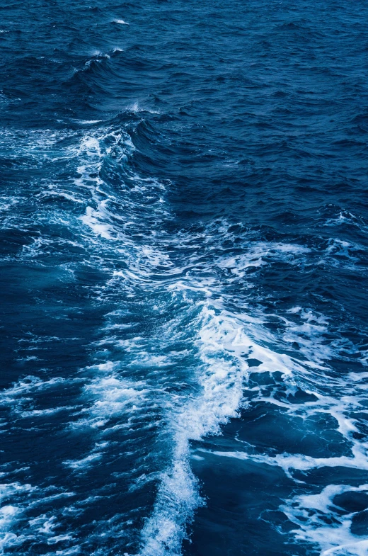 water in the ocean that is blue with some waves