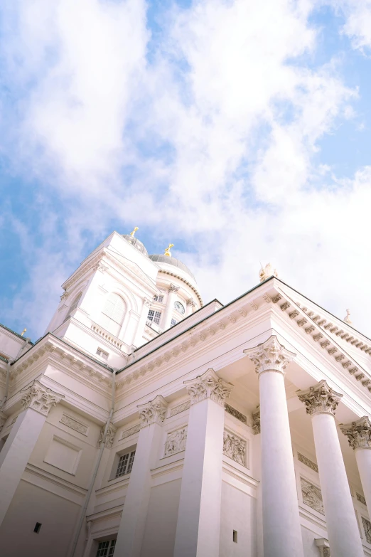 a large white building with columns and a clock tower