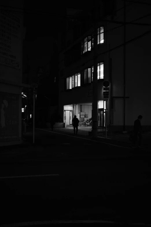 man standing outside of a building in the dark