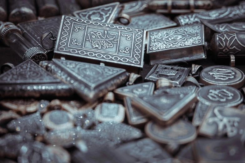 several silver metal items with small, ornamental patterns