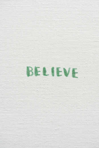 a piece of paper with the word believe written in green ink