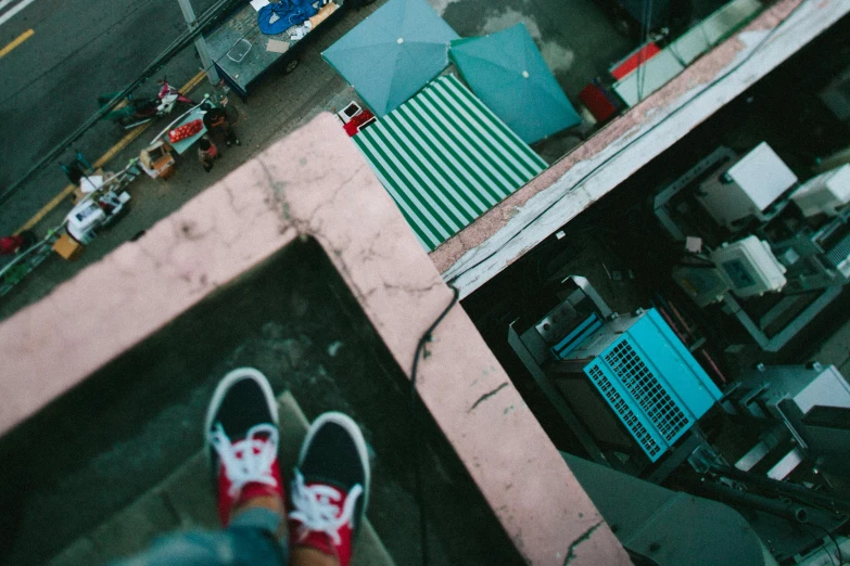 person wearing shoes standing by a building