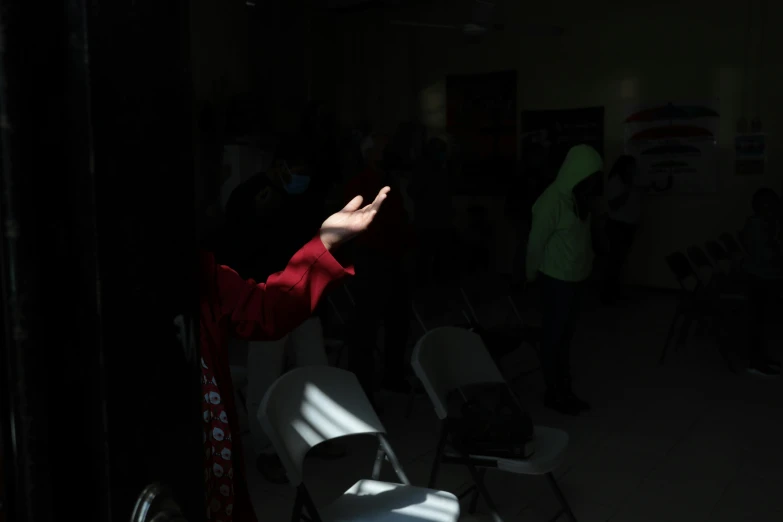 a person in red jacket holding up their hands