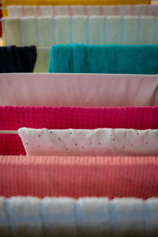 folded colorful towels and linens in rows