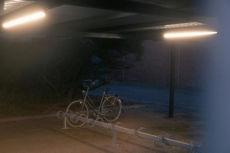 an empty parking space with lights over the bike