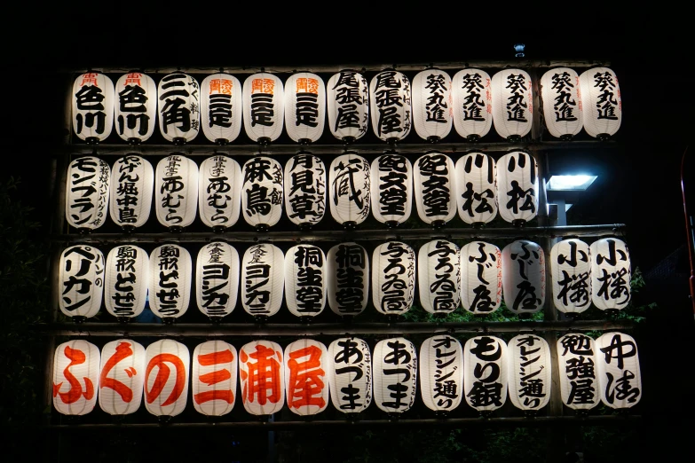 the back side of a wall that has different signs in many languages on it