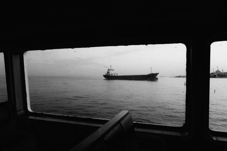 a black and white po shows a large boat in the ocean