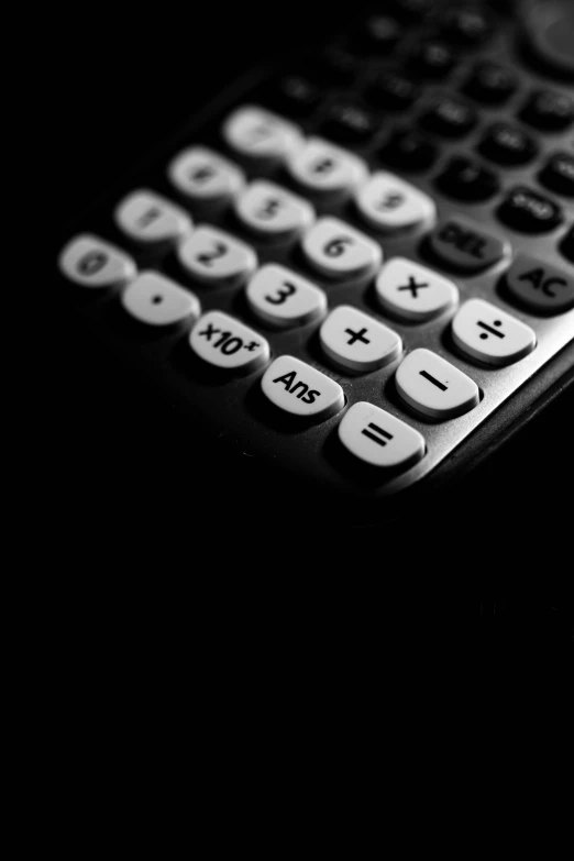 a close up of a black and white remote control