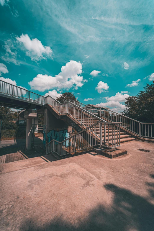 a long stair case with stairs and a person standing under it