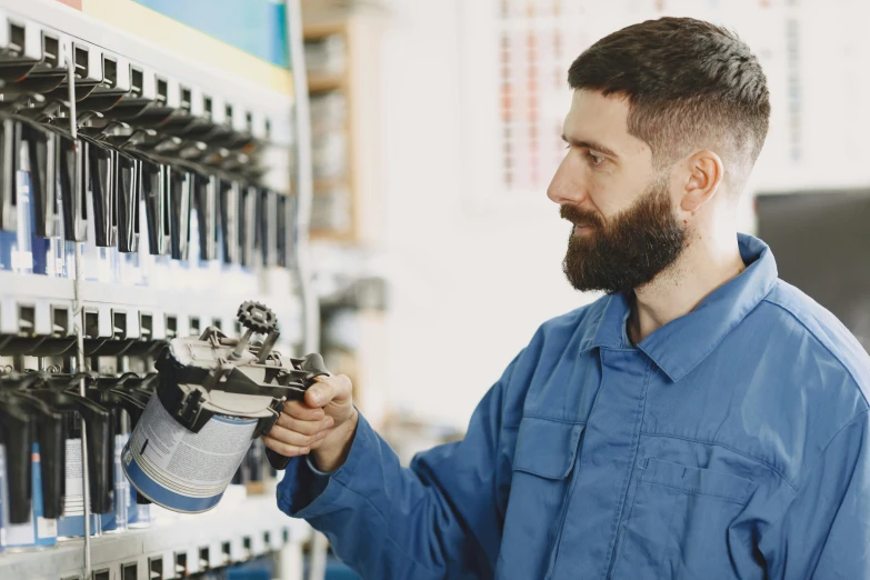 a man is using a machine with nozzles to control